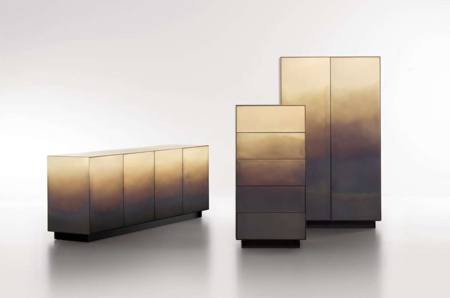Reflective modern storage cabinets with a gradient metallic finish in gold and bronze tones.