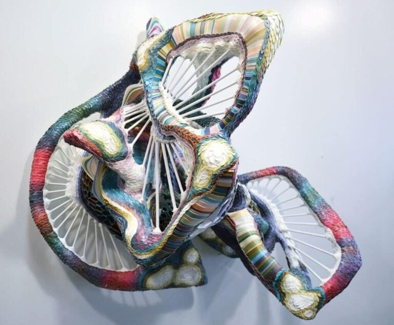 Crystal Wagner Weaving Coloration And Nature Into Its Own Organic Structure Colorful mixed media sculpture with vibrant stripes and organic forms, displayed at Visual Atelier 8.