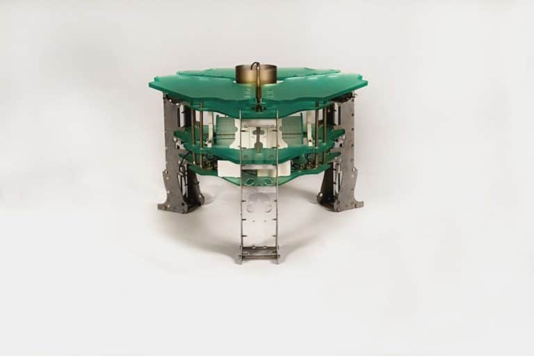 Reina Mun about Crafting Tangible Narratives that foster Meaningful Experiences and Connections High-tech robotic component with layered green circuit boards and metal framing, showcasing advanced electronic engineering.