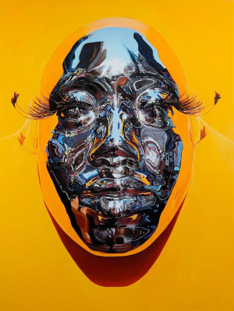 Interview With Kip Omolade Intricate metallic face sculpture with exaggerated eyelashes on vibrant yellow background.