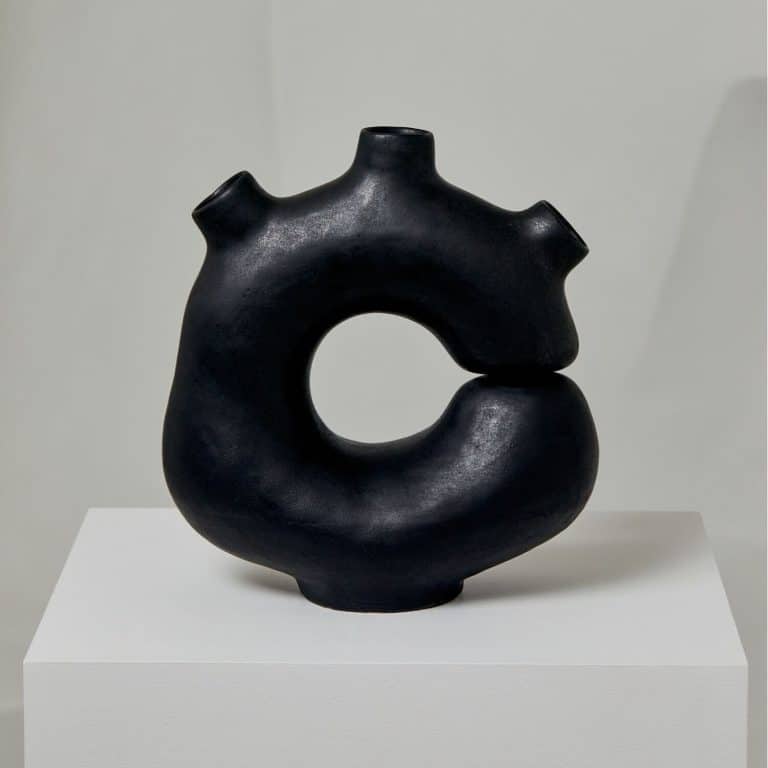 The Permanent Collection By Simone Bodmer-Turner Studio Contemporary black ceramic sculpture with a circular form and abstract design.