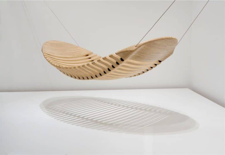 Adam Cornish's Wooden Hammock Mimics The Human Spine Sculptural wooden hammock with innovative slatted design and suspended wires.