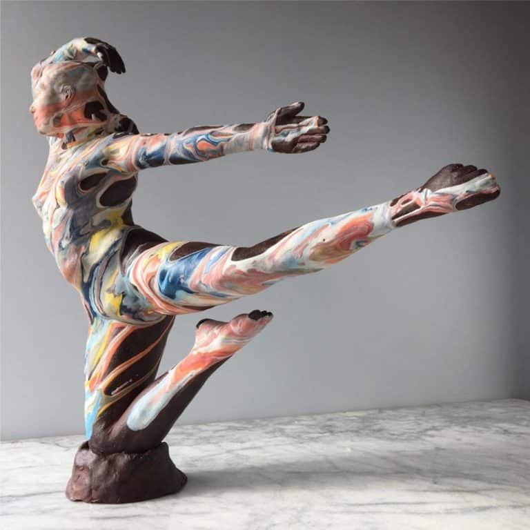 Adrien Miller Creates Items Of Comfort With Ceramics Vibrant colorful marble sculpture of a dancer in a dynamic pose, demonstrating contemporary art and modern sculpture techniques.
