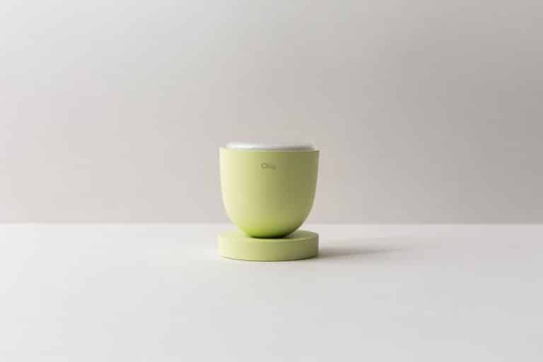 Green modern skincare jar on a minimalist white background.