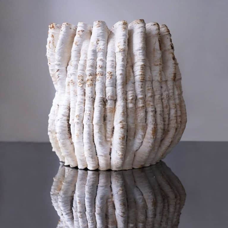Blast Studio Designs Striking Objects From Nature White textured sculpture made of stacked organic shapes, modern ceramic art piece.