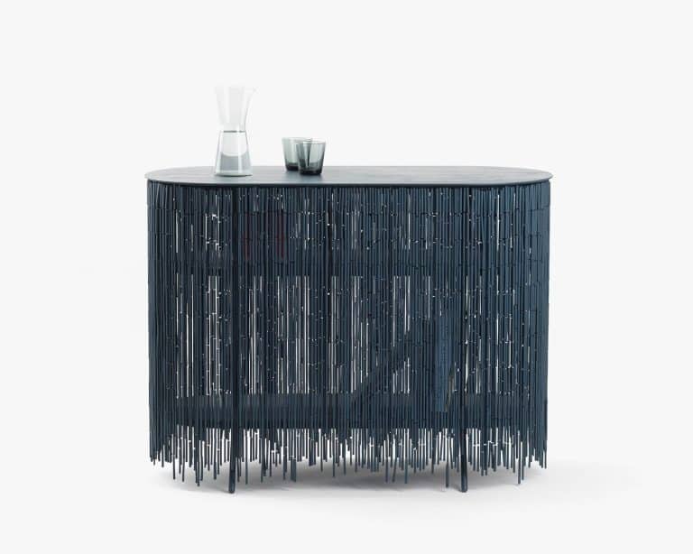 Calen Knauf Studio Masks The Objects Contained Within A Keefer Modern black metal console table with intricate vertical rod design for contemporary interior decor.