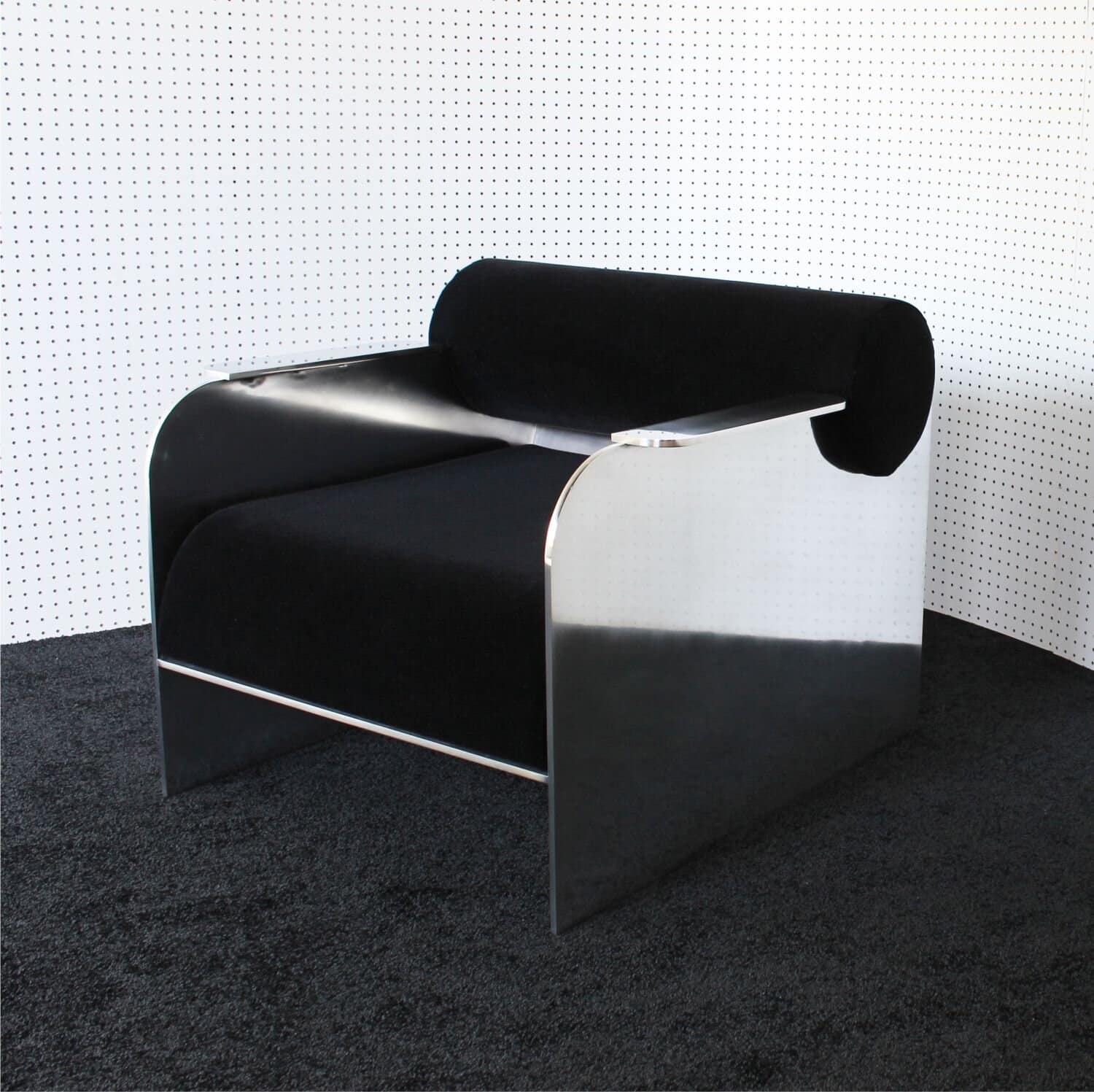 Contemporary black and silver designer lounge chair with modern aesthetic.