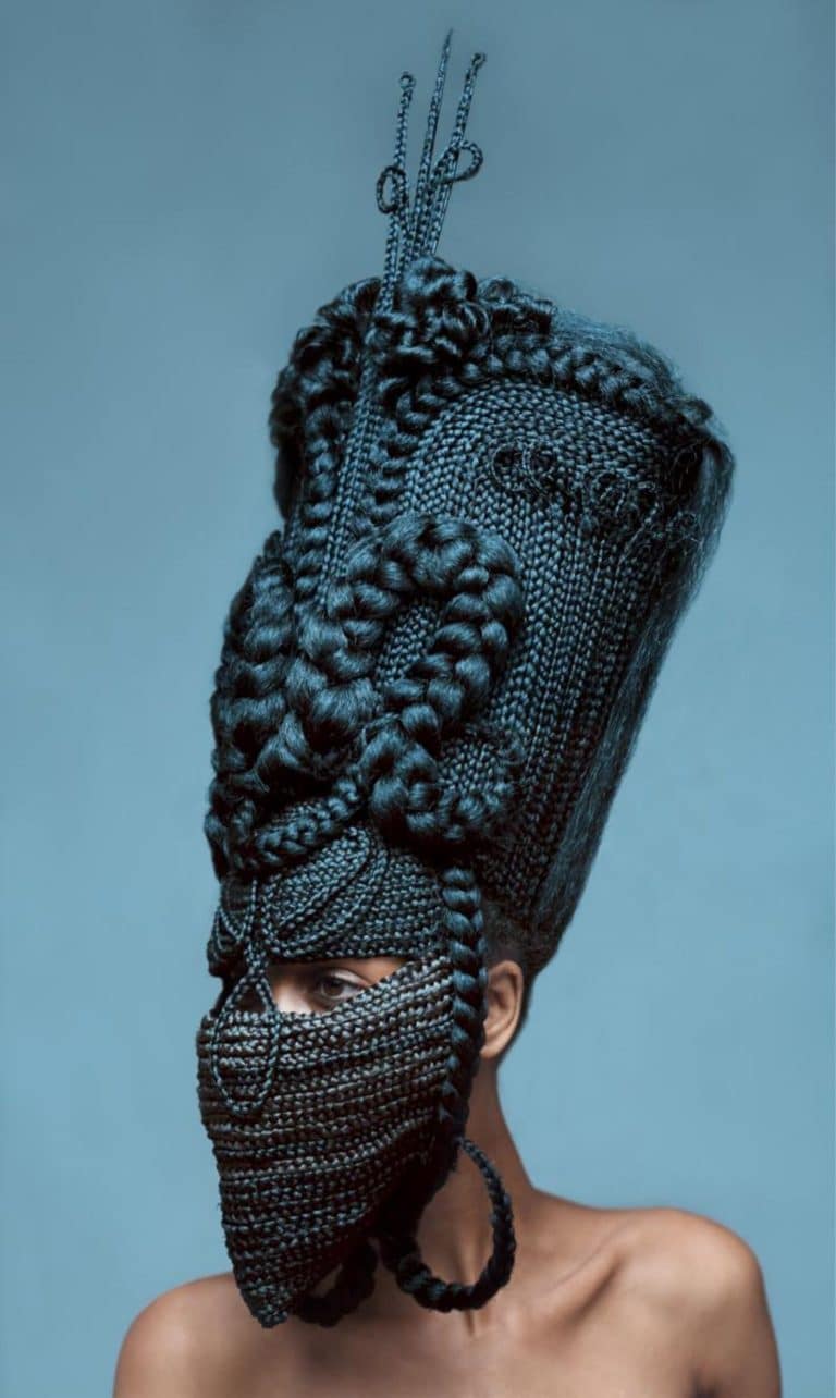 Delphine Diallo Delves Into The Culturally Significant Narrative Intricate black braided headpiece and face mask with elaborate beadwork and textile details.