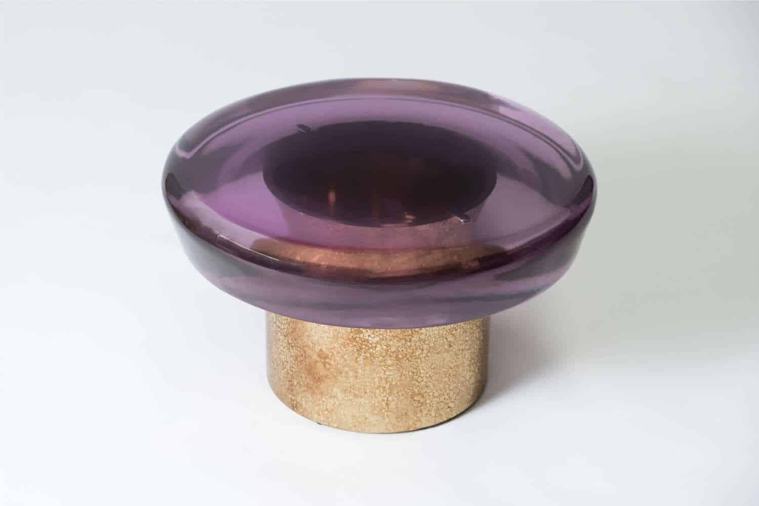 Vibrant purple glass bowl with beige textured base, modern decorative art piece.