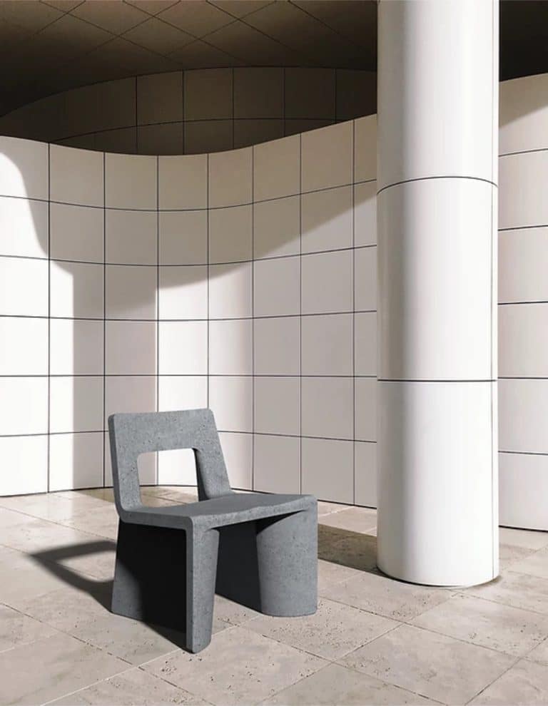The Distinct And Industrial Character Of Fly-Ash Chair By Erica Stine Modern architectural concrete chair with minimalist design in front of curved tiled wall.