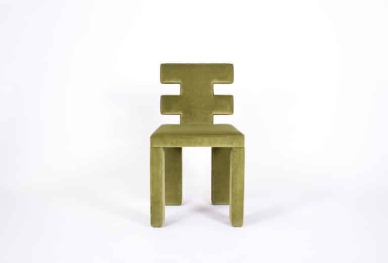 Estudio Persona Defines A Volume Through The Subtraction And Repetition Green velvet modern chair with geometric backrest in minimalist style.