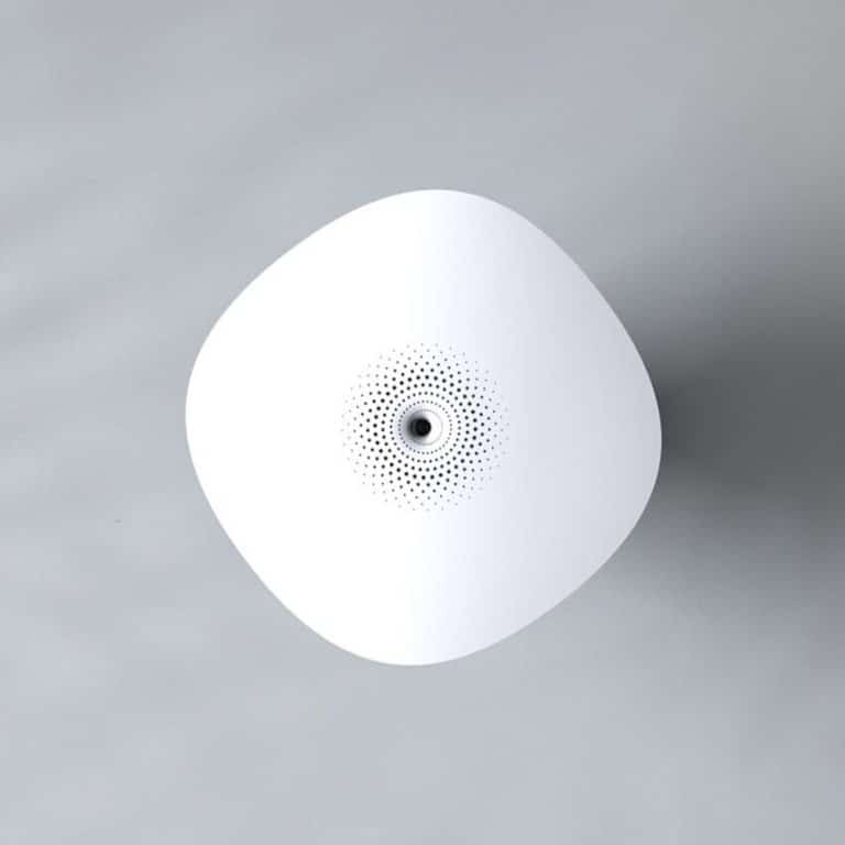 Minimalist white conceptual speaker with dotted design on gray background.