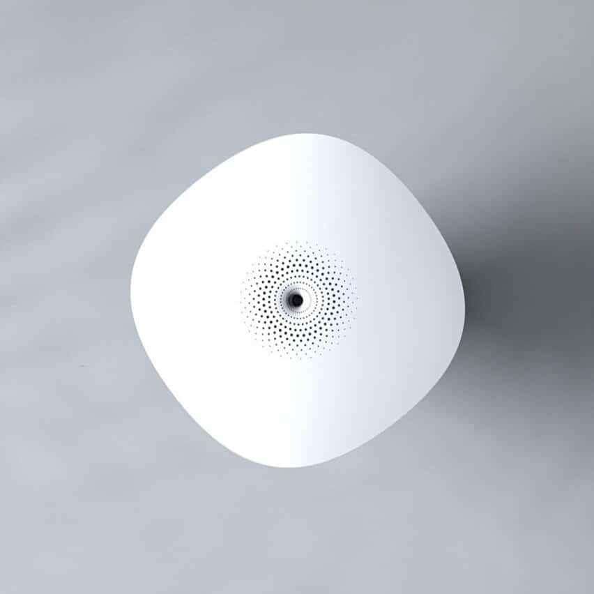 Minimalist white conceptual speaker with dotted design on gray background.