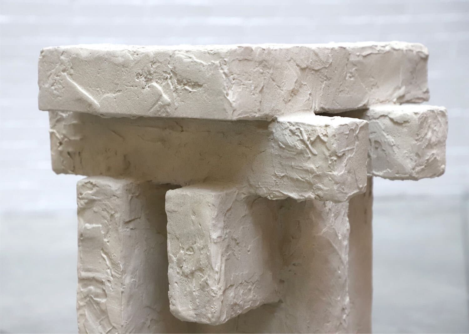 Natural white textured stone sculptures with rustic finish and artistic detail.