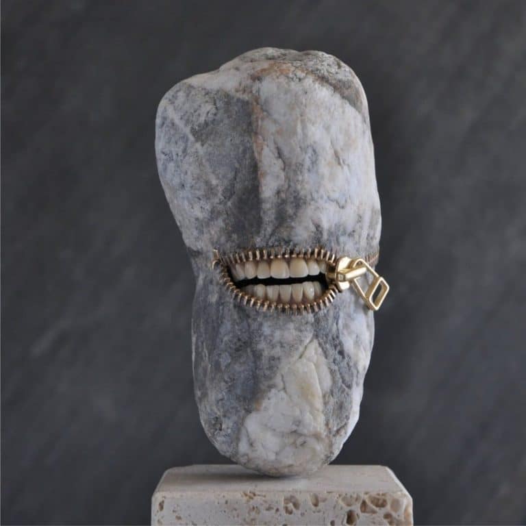 Hirotoshi Ito Creates Intriguing Stone And Marble Sculptures Zipper mouth sculpture made of rock with teeth on a pedestal, contemporary art piece.