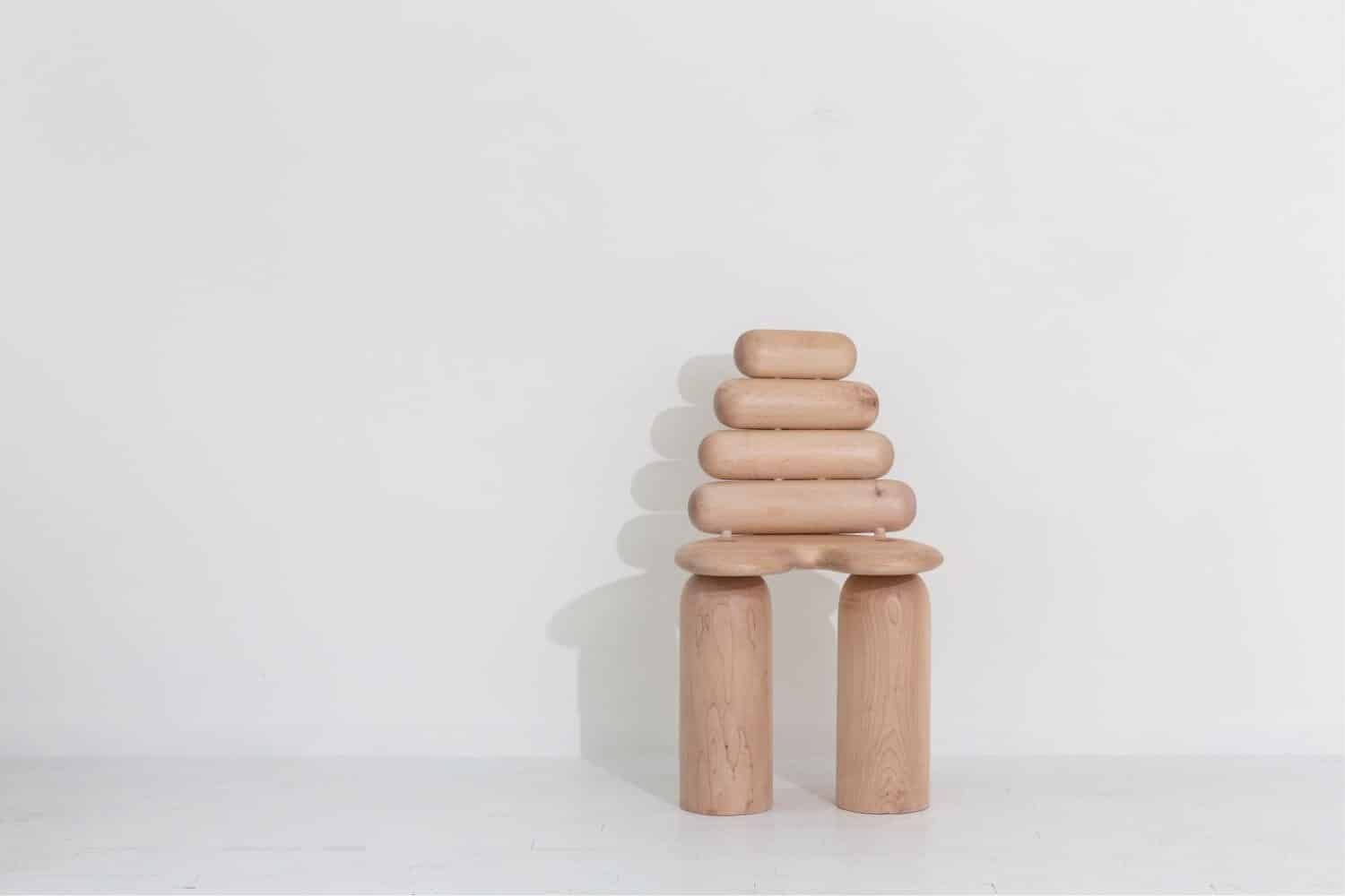 Natural wooden stacking sculpture with minimalist aesthetic, modern art decor.