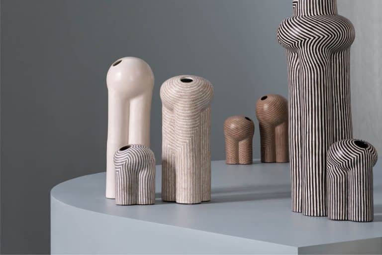 Jeremy Anderson's Anthropomorphic Creatures Of Piccolo Parade Contemporary ceramic vases with geometric patterns and earthy tones displayed on a minimalist table.