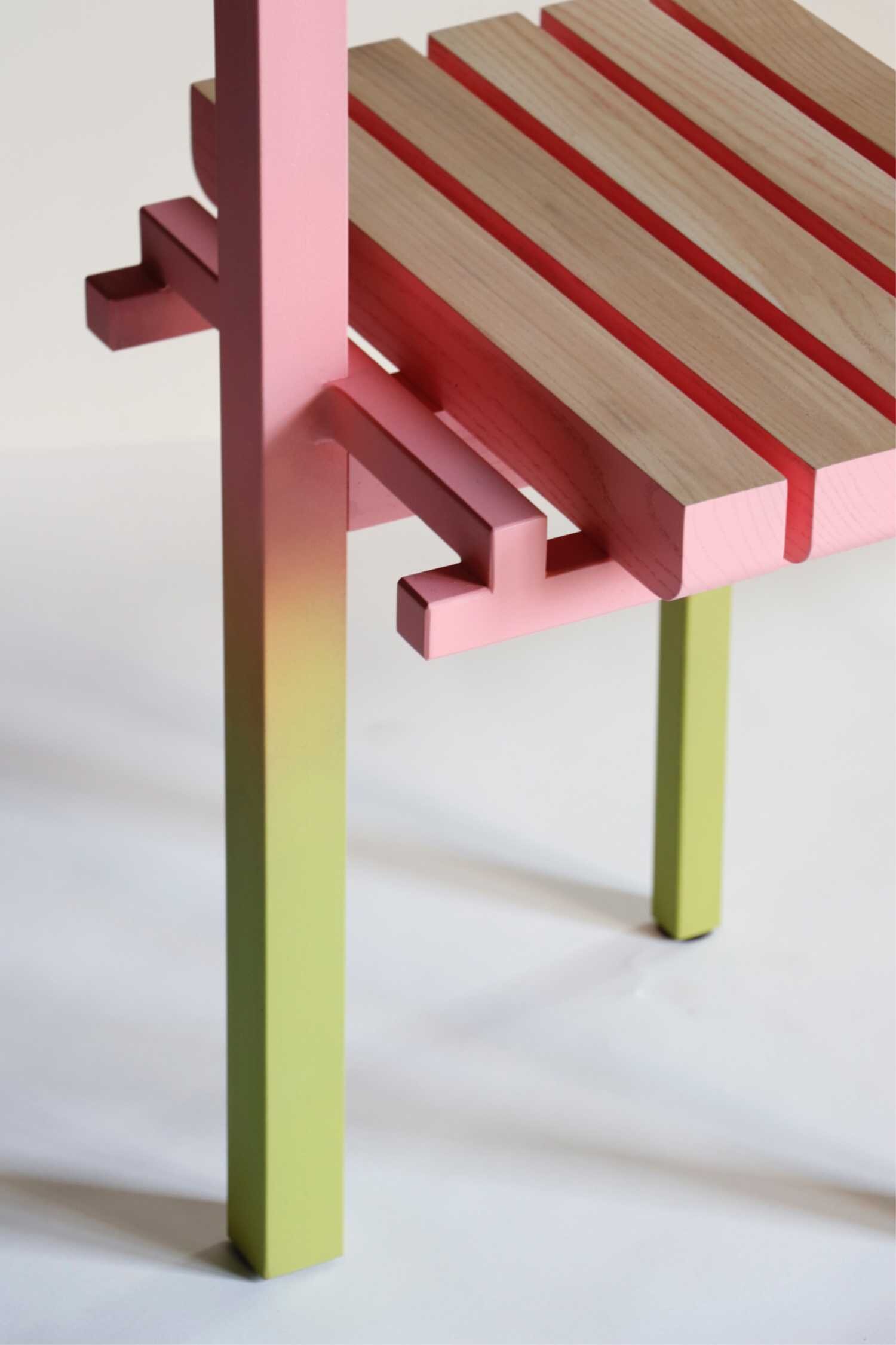 Colorful modern wooden bench with pastel pink, green, and natural wood finishes.
