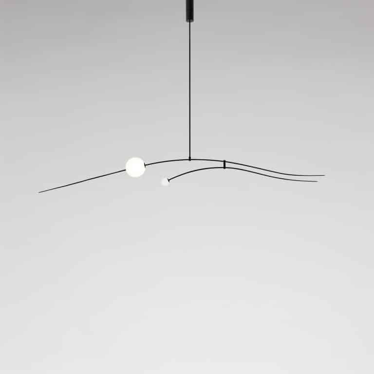 Michael Anastassiades Assembles The Equilibrium Of Mobile Chandeliers Sleek modern pendant LED light fixture with curved black metal arms and white spherical bulbs.