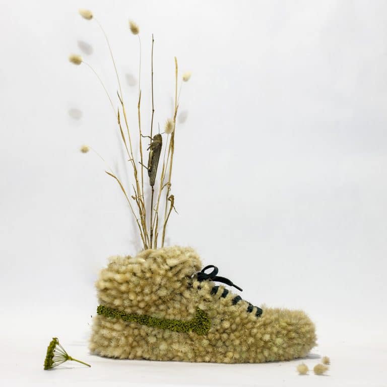 Monsieur Plant Creates Plant Based Sculptures And Installations Fuzzy beige sneaker with dried flowers and grass, minimalistic design, soft textures, and natural elements.