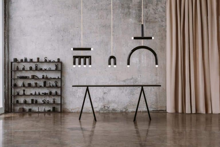 Nonexistent Alphabet Of TRN Collection By Pani Jurek Modern industrial interior with minimalist black lighting fixtures and decorative objects.