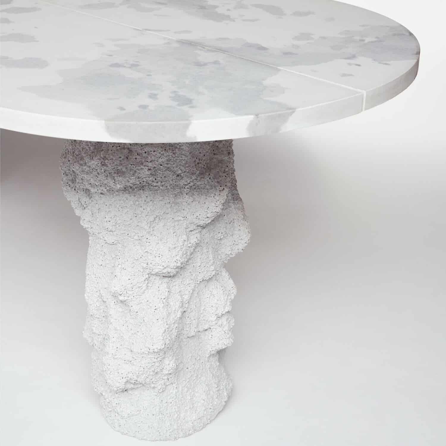 Vibrant concrete table with a polished marble top and textured sculptural base, modern design for contemporary interiors.