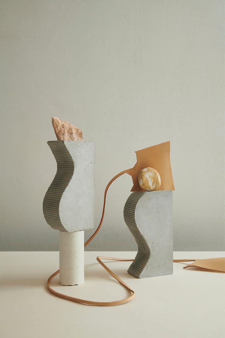 Sarah Naud Extends Her Graphic Practice To The Material Crafting Concrete abstract sculptures with textured surfaces and organic shapes, modern minimalist design.