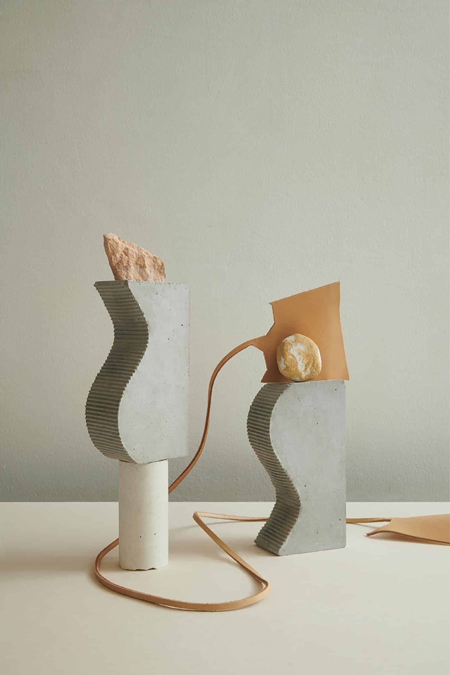 Concrete abstract sculptures with textured surfaces and organic shapes, modern minimalist design.