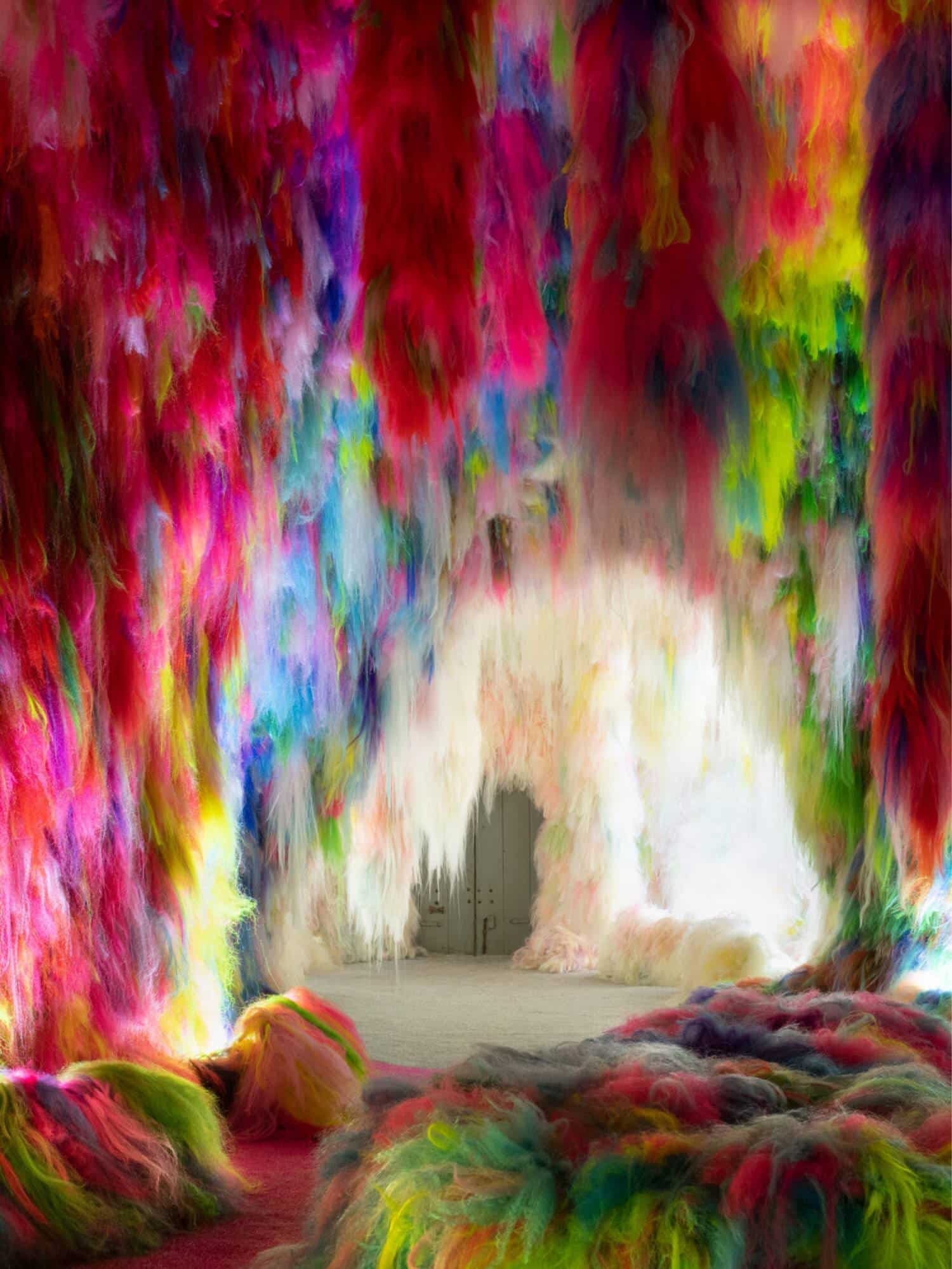 Vibrant colorful fiber art installation with multicolored fluffy textures and dynamic visual impact.