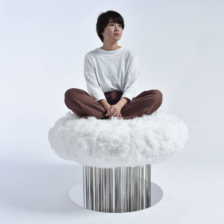 Shota Urasaki Designs A Cloud-Like Raining Chair Thoughtful woman sitting on a fluffy white cloud with a barcode base.