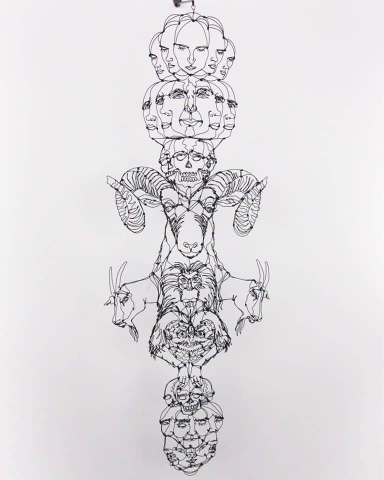 Spenser Little Sculpts Wire Portraits And Word Play Street Art Intricate wire sculpture featuring faces, animals, and skulls symbolizing life and death.