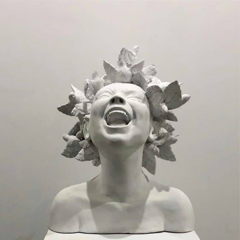 Tania Font Creates Extraordinary Childlike Sculptures Betty davis sculpture with expressive face and detailed butterflies, contemporary art piece for modern interior design.