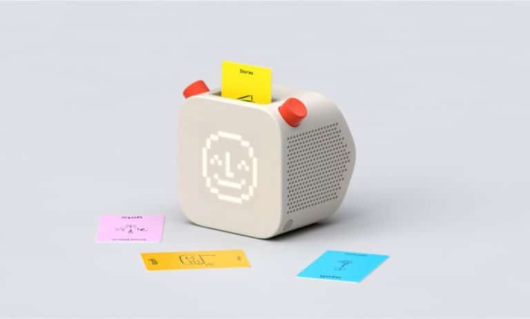 Vintage pixel art smiley face speaker with colorful sticky notes and notes on plain background.