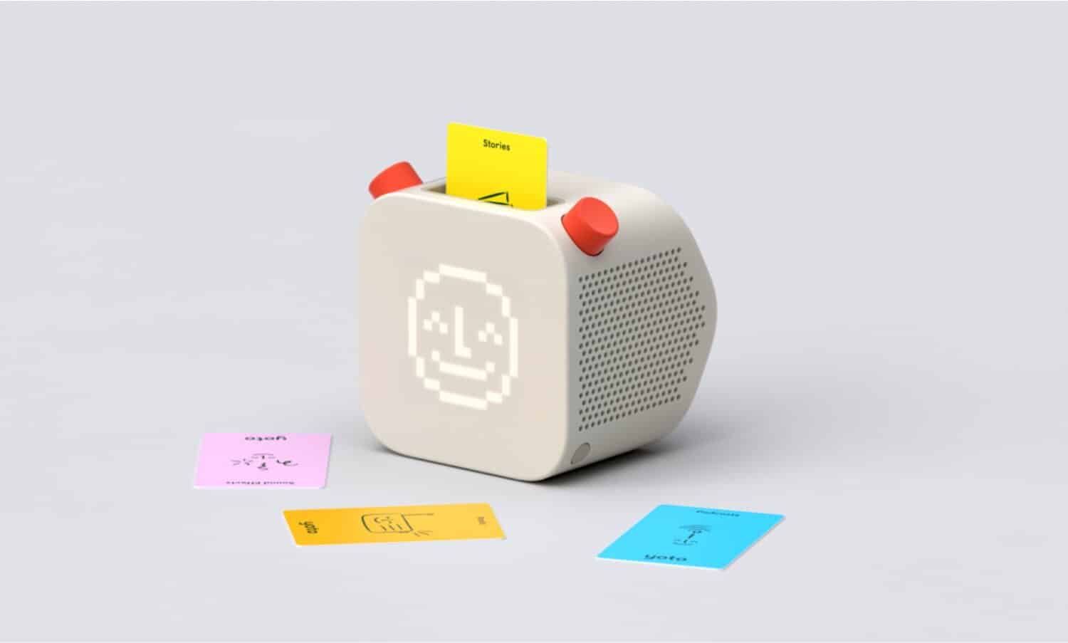 Vintage pixel art smiley face speaker with colorful sticky notes and notes on plain background.