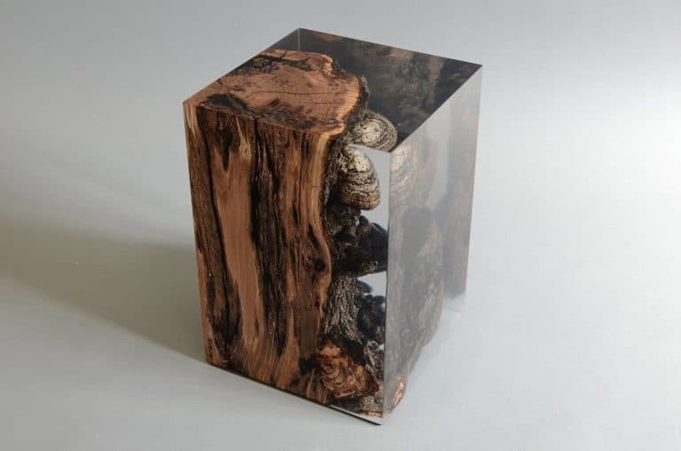 Alcarol Explores The Mythology Of Genius Loci Glossy resin and wood art sculpture with natural textures and embedded stones for modern aesthetic.