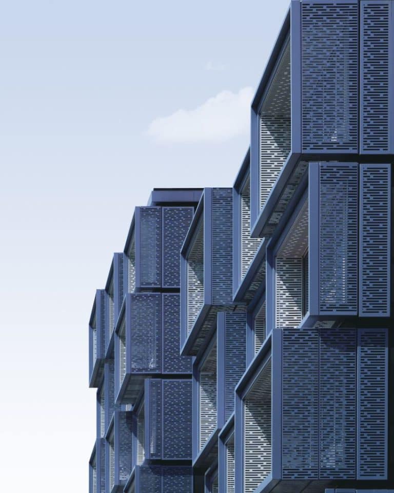 Renting Heavy Equipment For Architectural Projects Futuristic modern building with geometric blue facade, architectural design, and perforated metal panels.