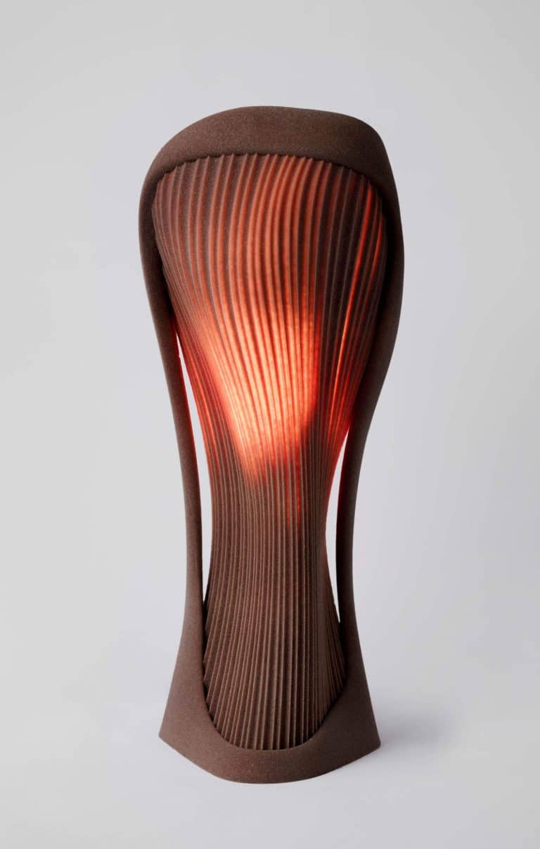 Rollo Studio's Dune Collection: Where Nature and Technology Illuminate Sleek modern wooden table lamp with sculptural design and warm ambient lighting.