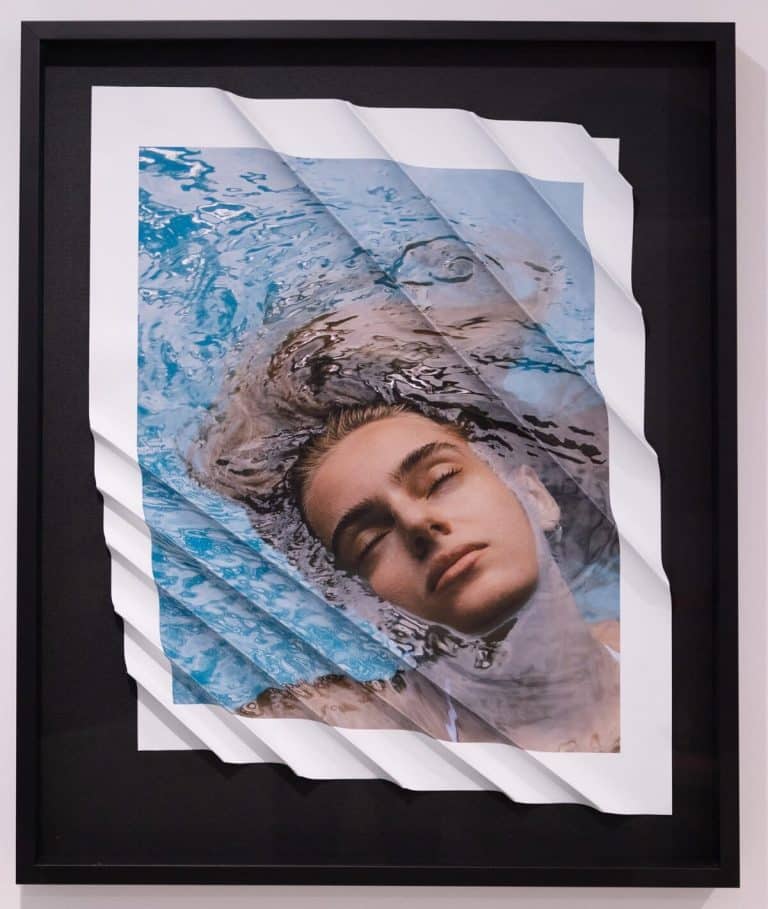 Dustin Ha is capturing the unseen in his Debut Exhibition "REMEMBER WHY YOU’RE HERE" Framed photo of a woman relaxing in water, crumpled photo print effect, contemporary wall art for modern interior decor.