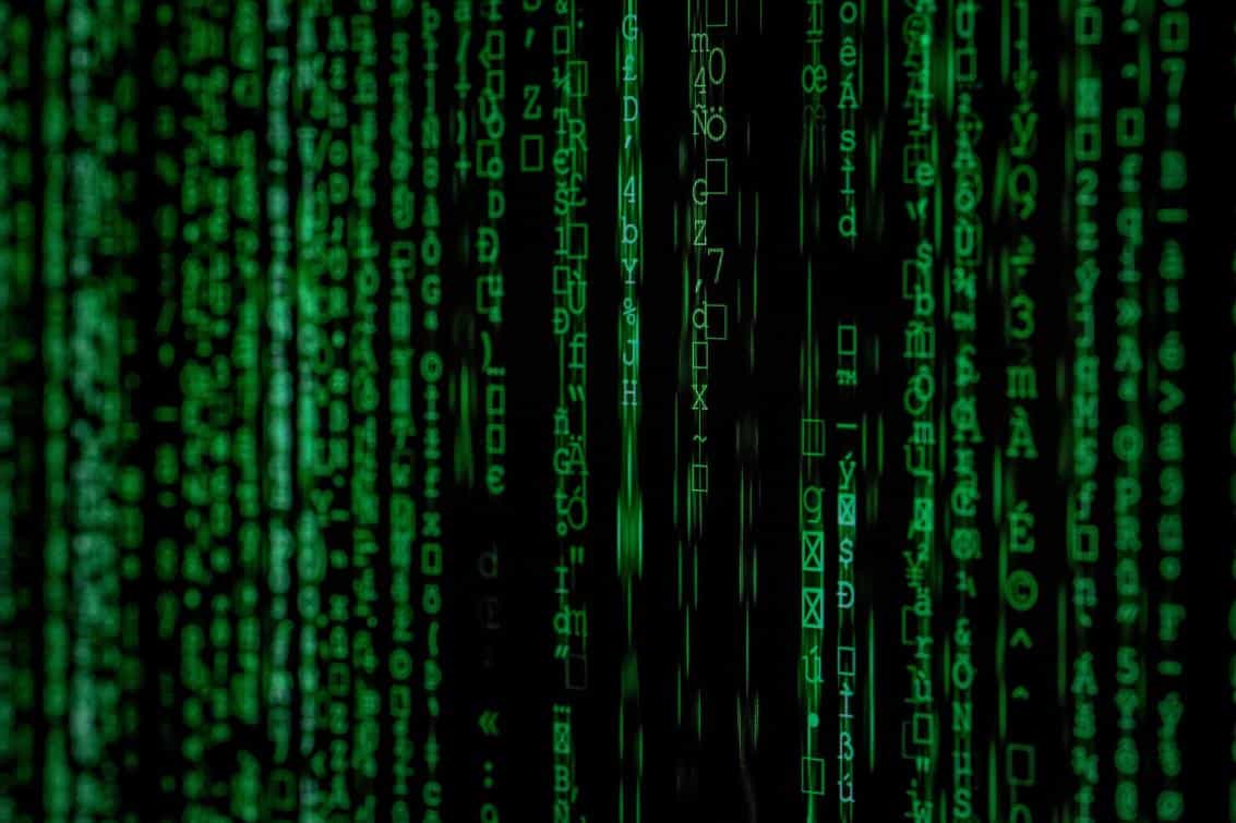 Digital green matrix code inspired by computer programming and cybersecurity themes.