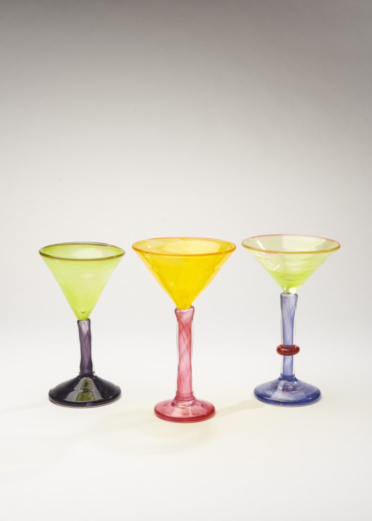 Vibrant colorful glassware set with three stemmed glasses in lime green, yellow, and blue hues, showcasing artisanal glass design.
