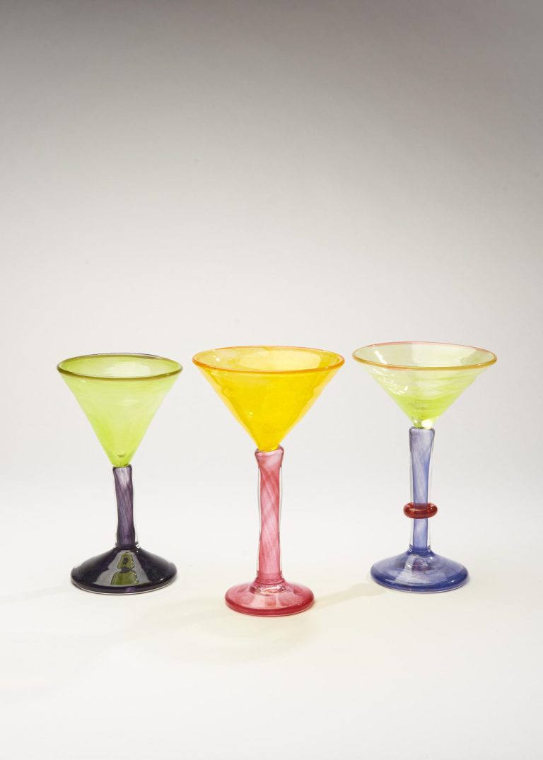 Boris de Beijer is Blending Tradition and Innovation in Glass Artistry Vibrant colorful glassware set with three stemmed glasses in lime green, yellow, and blue hues, showcasing artisanal glass design.