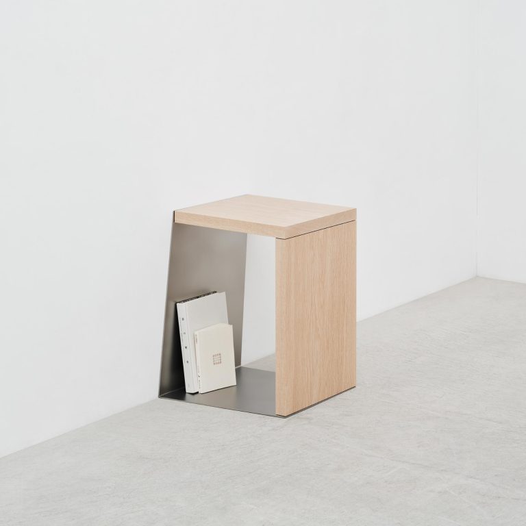 The Poetic Depth of NAO IWAMATSU's "By Shadows" Furniture Series Minimalist wooden side table with metal interior shelf holding books, modern decor.