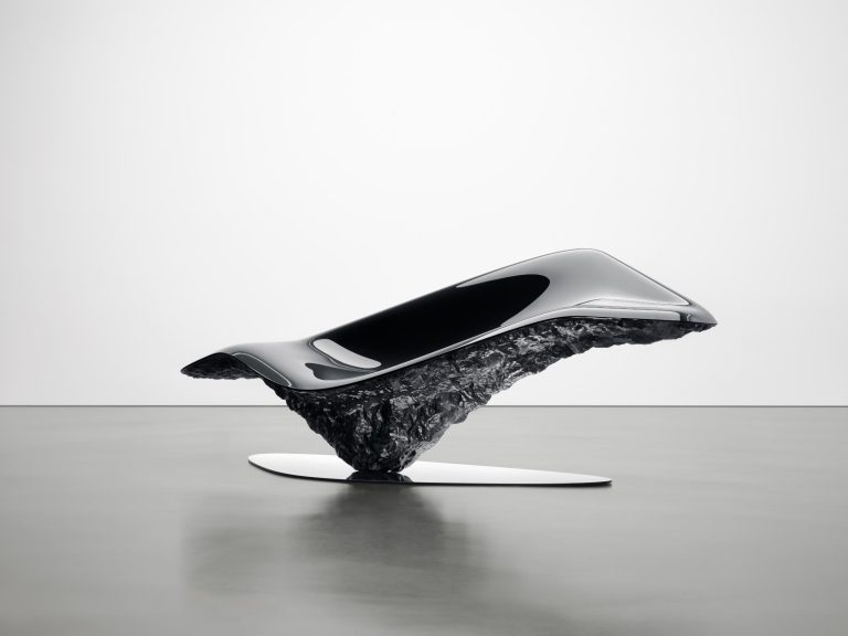 Oksýs: A Fusion of Nature and Innovation in Pininfarina's First Collectible Design Sleek futuristic concept car with a high-gloss black finish on a textured black base.