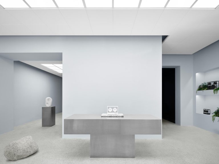 Transparent Unveils Innovative Sound Room in Stockholm White contemporary art gallery interior with sculptures and plants, minimalist design and clean lines, modern art exhibition space.