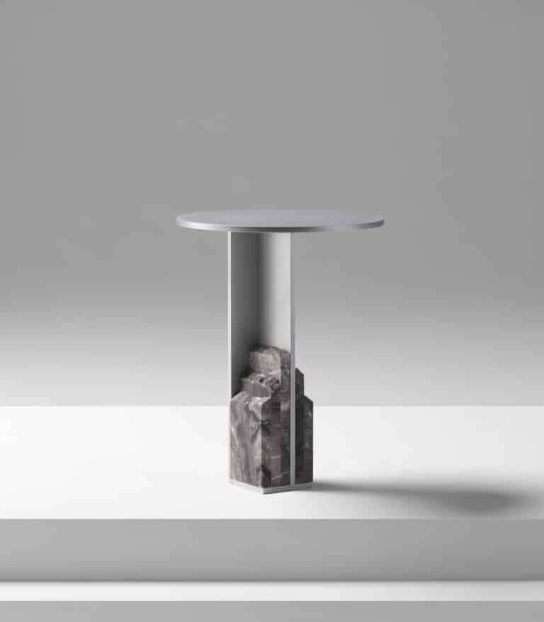 Ross Gardam's Mass Table Harmonizes Natural and Industrial Modern minimalist side table with marble base and sleek metal top.