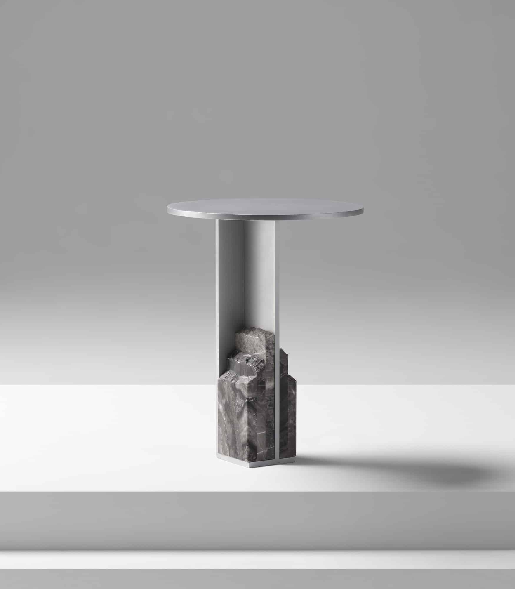 Modern minimalist side table with marble base and sleek metal top.