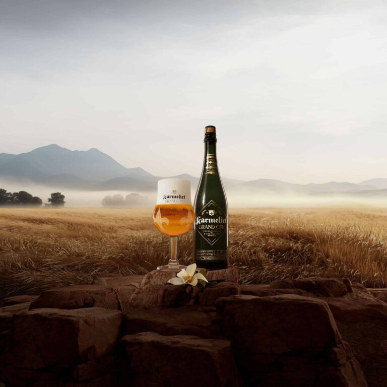 Elegant beer on stone pedestal amidst serene, golden-hued landscape; inviting relaxation in nature.