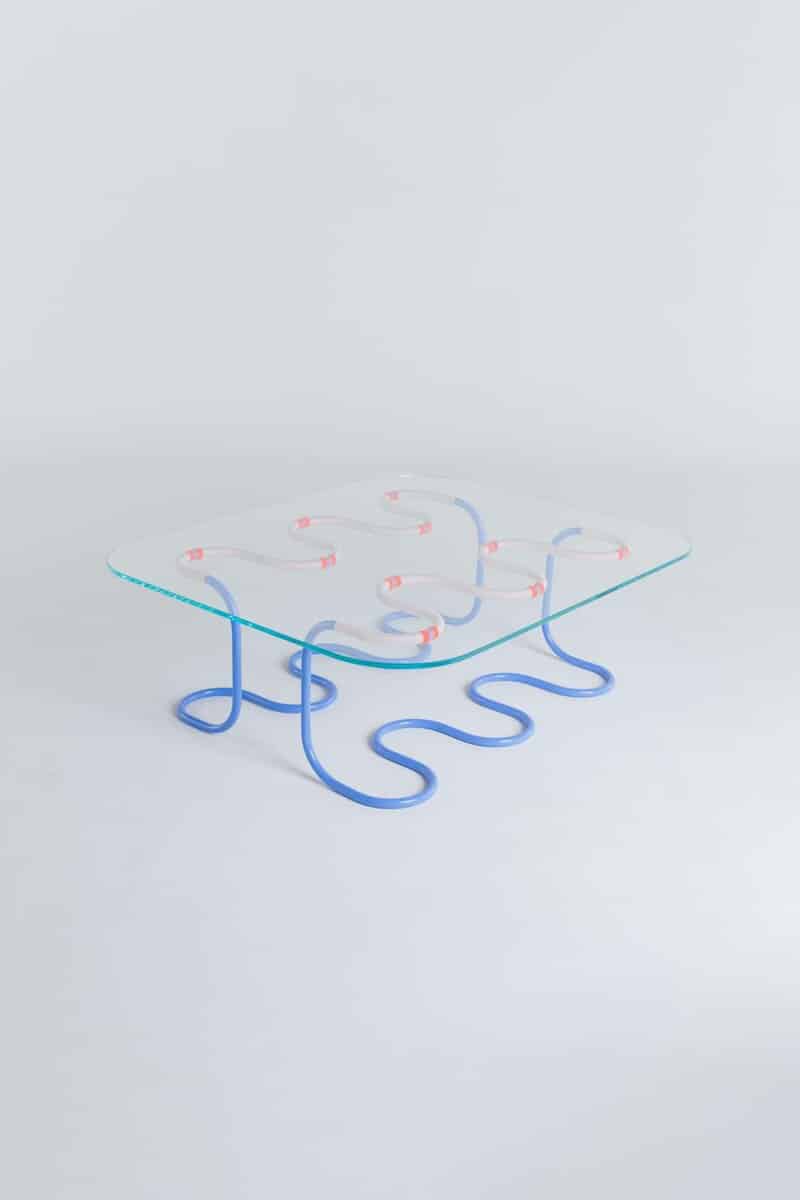 Colorful neon light sculpture with curvy blue and pink tubes, modern design on a minimalist white background.