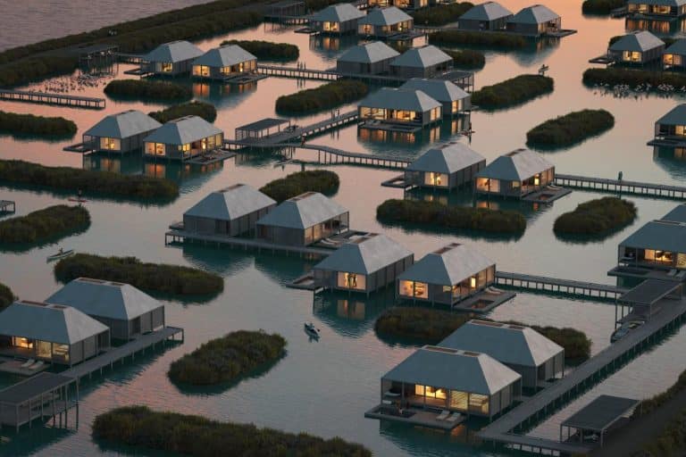 MAST presents Eco-Friendly Hotel concept on Abandoned Portuguese Salt Production Site Overwater bungalows at sunset in a tropical lagoon.