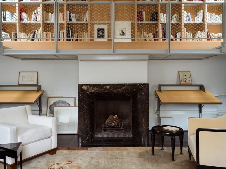An interview with Marie Anne Derville’s on her Eclectic Vision in Design Modern living room with cozy fireplace, bookshelves, and elegant furniture, showcasing contemporary interior design.